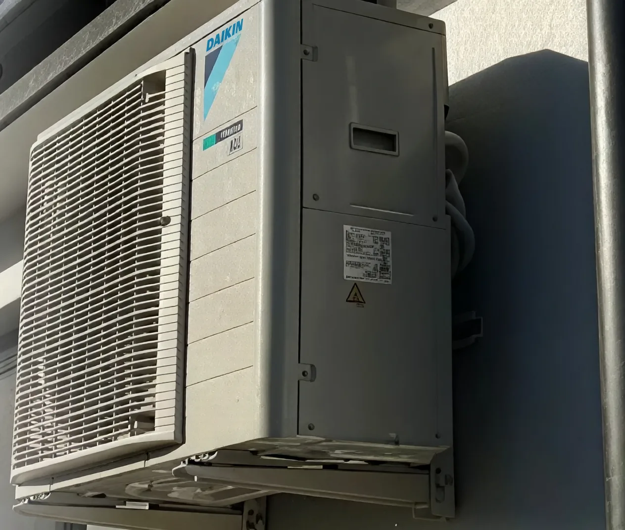 Daikin outdoor unit mounted on a house wall