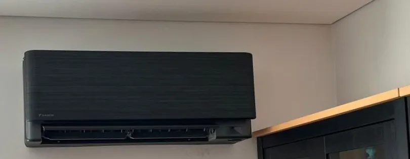 Black Daikin wall-mounted split system in a living room