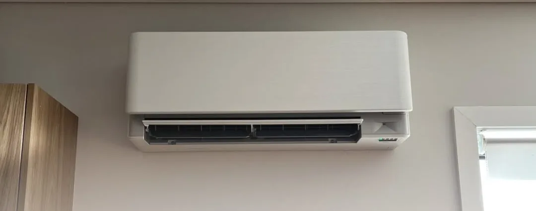 White wall-mounted split system installed in a bedroom